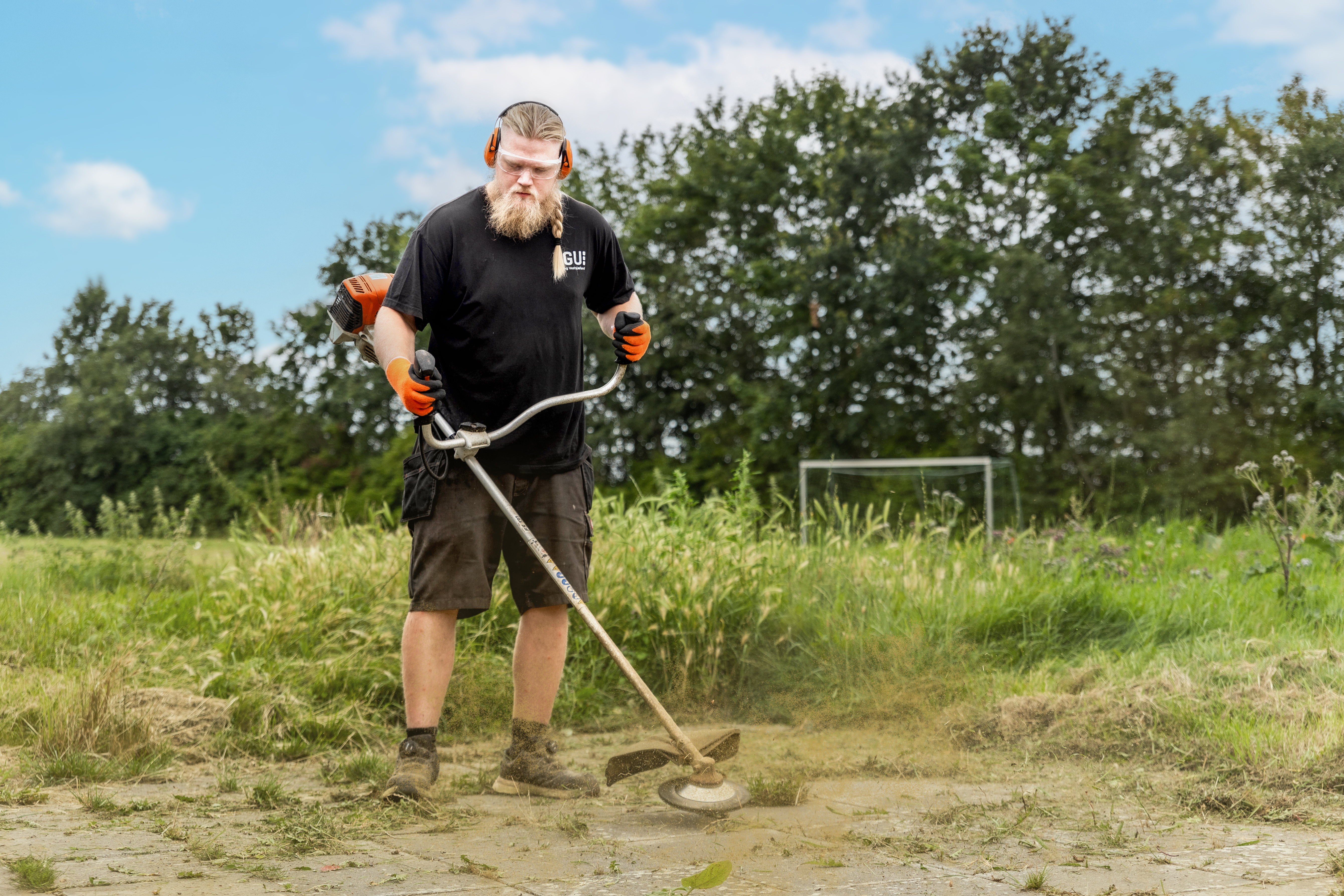 En mand står men en buskrydder